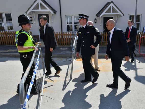 Home Secretary Sajid Javid (right) meets police officers and residents at Muggleton Road in Amesbury, Wiltshire