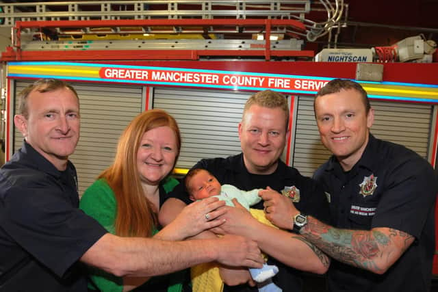Francesca and Thomas with the firefighters who saved his life