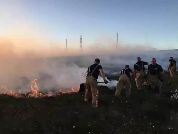 Firefighters tackle a blaze on moorland. A reader says they deserve our gratitude and support