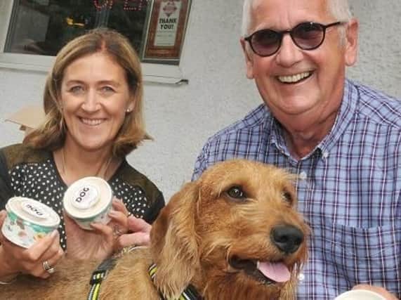 Donna Townson from Fredericks Ice Cream and regular customers Paul Wren and dog Murphy, who enjoys the ice cream especially made for dogs and, inset, Murphy enjoying his treat