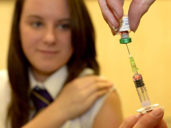 A teenager getting the measles jab