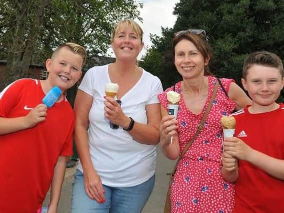 It was hot enough yesterday at Haigh Hall - from left: Ben Hilton, 12, Sharon Hilton, Vicky Bennett and Dylan Bennett, 12, chilled with lollies and ice creams