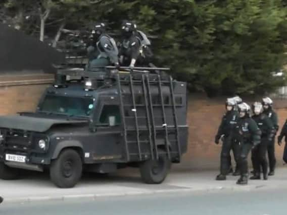 Armed officers prepare to begin their raid