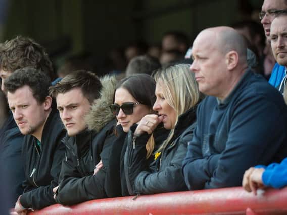 Despondent Wigan fans watch their team play before being relegated into League One in 2015
