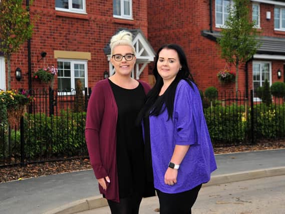 Twins Emma and Katie Edwards now live across the road from each other