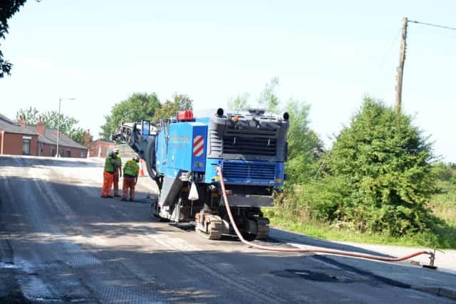 The old road surface being removed