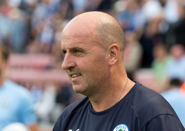 Paul Cook watches Latics against Sheffield Wednesday