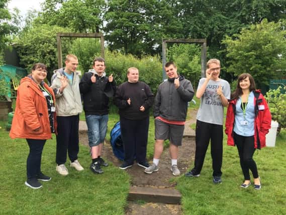 Young people from Landgate School in a sensory garden they are creating with staff from Wigan Council