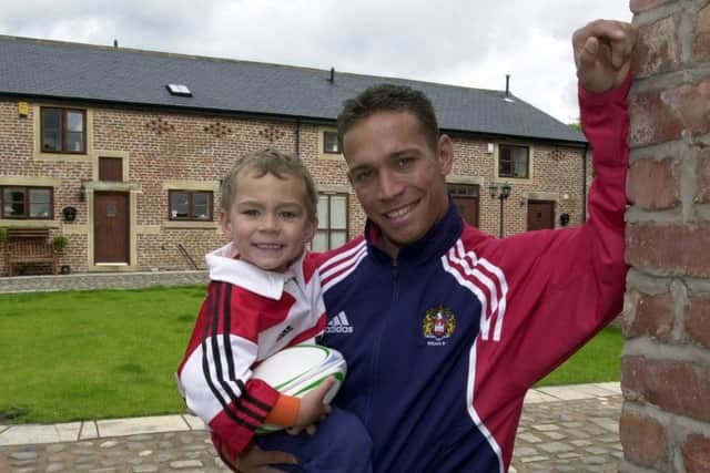 Lam as a Wigan player with son Lachlan