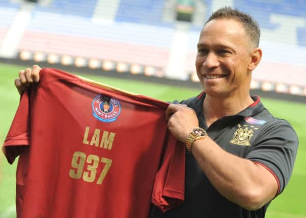 Adrian Lam showing a top with his heritage number