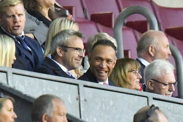 Wigan's next coach, Adrian Lam, shares a joke with Ian Lenagan's son, Simon. Mick Cassidy, next year's head of youth, was also in the directors' box (top left)