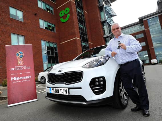 Neil Roden with the Kia car he has won