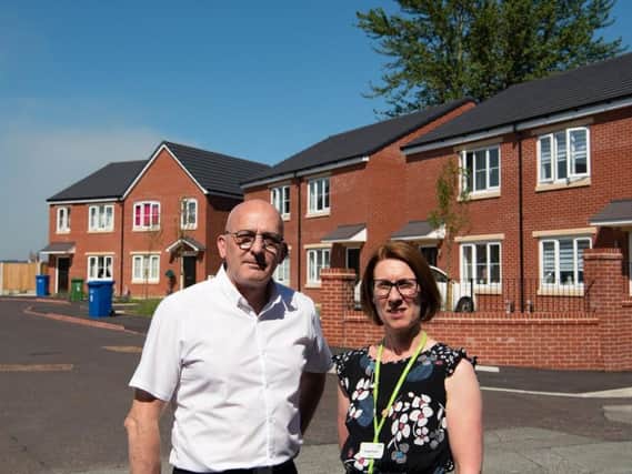Coun Terry Halliwell and resident Angela Durkin outside the recently built affordable homes in Holt Street