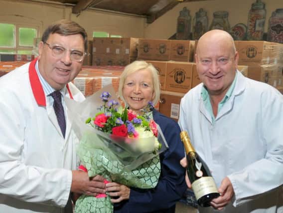 John, left, and Antony Winnard present Denise with her anniversary gifts