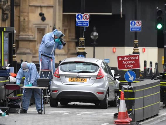 Forensic officers by the car, driven by Salih Khater, of Highgate Street, Birmingham