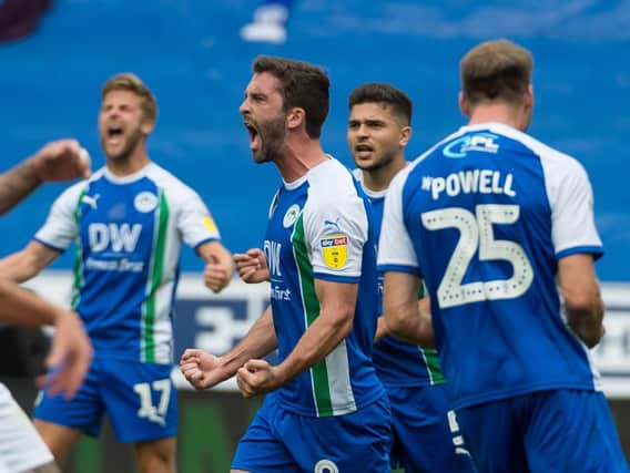 Will Grigg celebrates his goal against Nottingham Forest on Saturday as Latics continued their scoring run in their Championship return