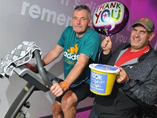 Fund-raiser Shaun Moran cycled 100km on an exercise bike, cheered on by friend Carl Waldie, as part of his challenge in memory of friend Gill