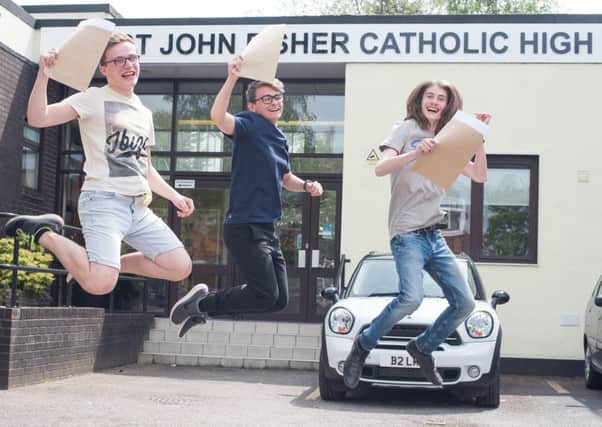 St.John Fisher students, David, Bailey and Daniel jump for joy as they receive their GCSE results