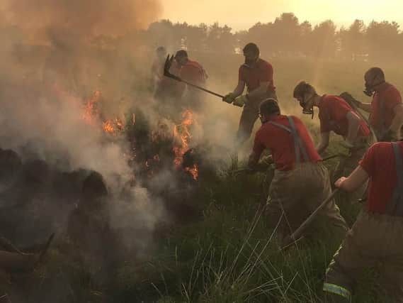 Firefighters tackle the fire at Winter Hill