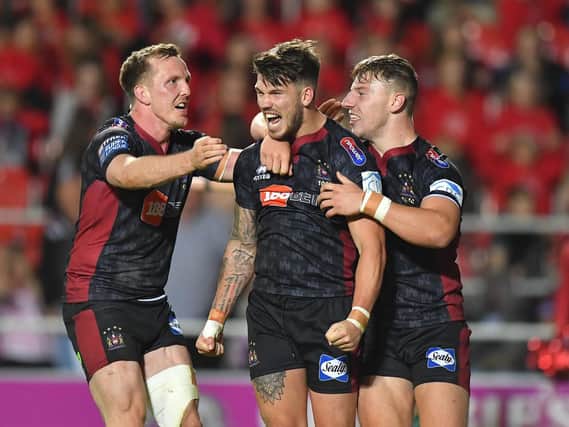 Dan Sarginson celebrates with Oliver Gildart and George Williams during the derby last week