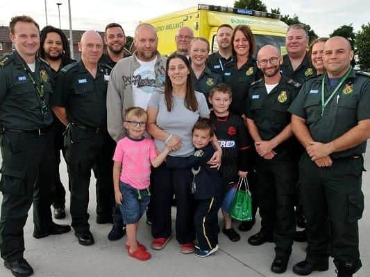 Lisa, husband Craig and their sons meet staff at Wigan Community Fire and Ambulance Station