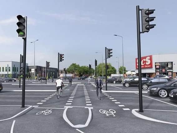 An artists impression of the planned new cycle lanes at The Saddle junction. It was revealed this week that more Wiganers would cycle each week if they felt safer on the roads