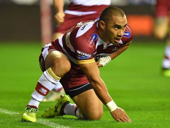 Thomas Leuluai touches down for Wigans first-half try but dislocates his finger in the process