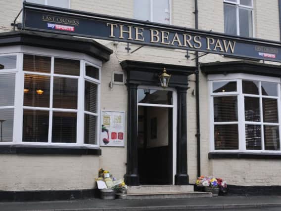 Flowers have been left outside The Bear's Paw pub, Hindley, in tribute to murder victim Lee Christy