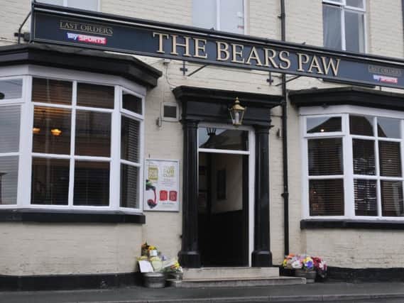 Floral tributes outside The Bears Paw in Hindley