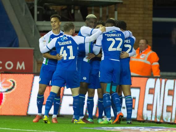 Wigan Athletic players celebrate on Friday night