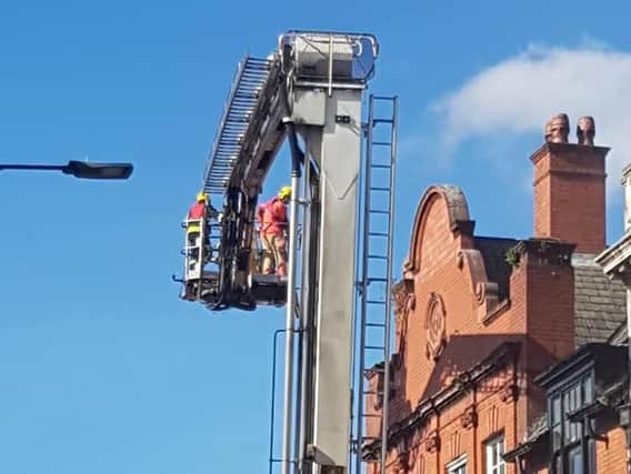 Firefighters are using aerial equipment to tackle the blaze. Photo by Nina Hodgson