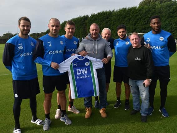 Wigan Athletic players present Tony Baldwin and Andy Gregory with a signed shirt to raffle at the rugby match they have organised to raise funds for Childrens Liver Disease Foundation and the North West Air Ambulance