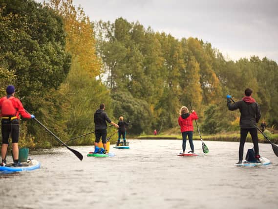Paddle boarders cleaning up the canal near Wigan Pier