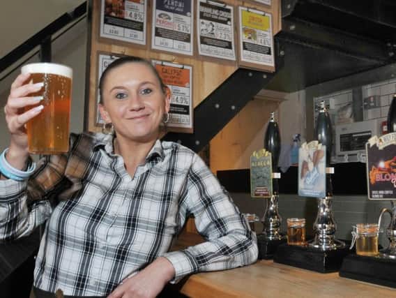 Christine Lamb serves a pint of ale at new bar Sherringtons