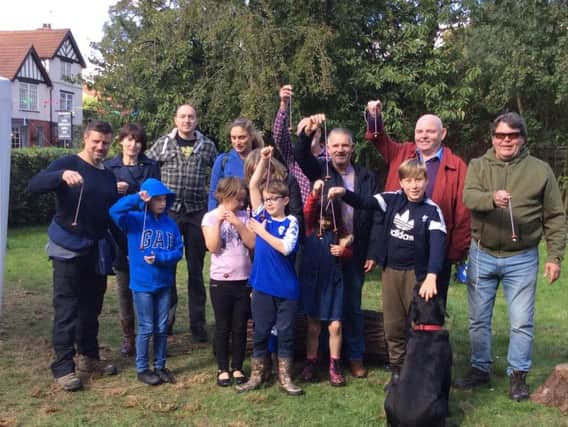 Competitors at the conkers tournament at the Cherry Gardens
