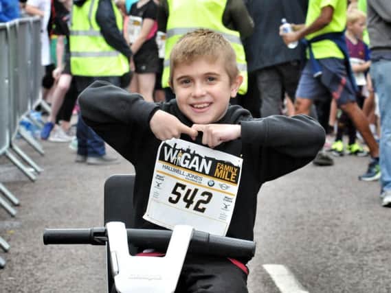 Ten-year-old Jack Johnson does the Joining Jack salute at the family mile held alongside the Wigan 10k last month