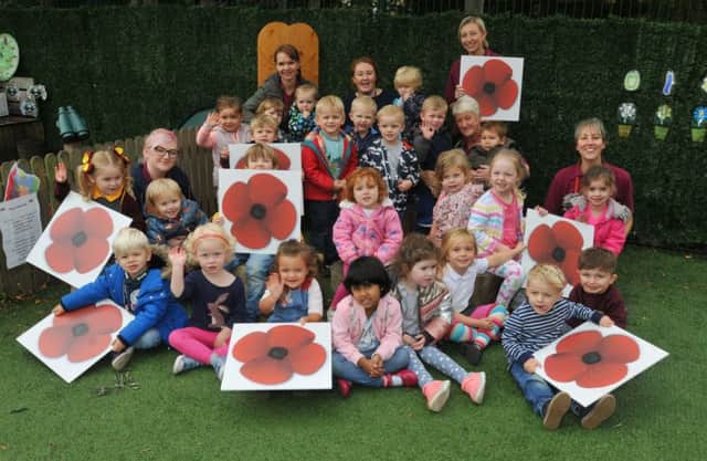 Kids and staff at Parbold Douglas Nursery, at Parbold Douglas C of E Academy primary school, Parbold, show their support for the Let's Turn the Town Red poppy campaign