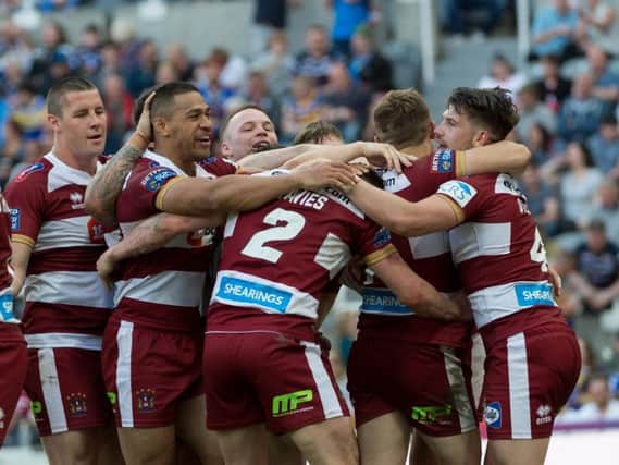 Warriors players celebrate a job well done at Magic Weekend