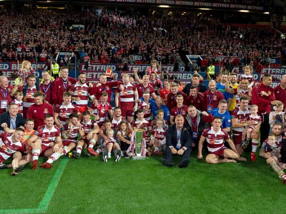 Wigan Warriors players celebrate the club's fifth Grand Final win