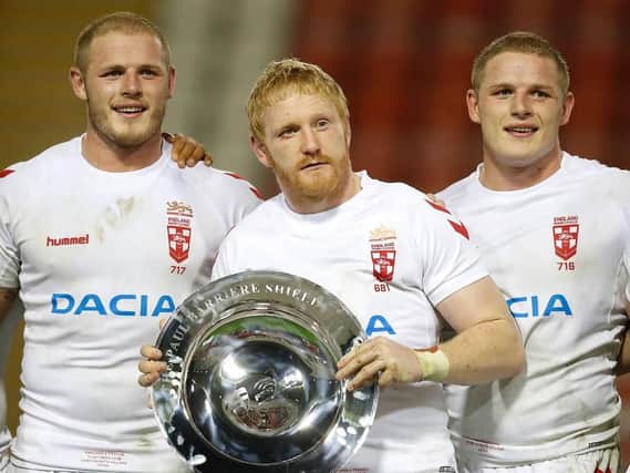 England's James Graham lifts the Paul Barriere shield after his team's win against France with Tom and George Burgess