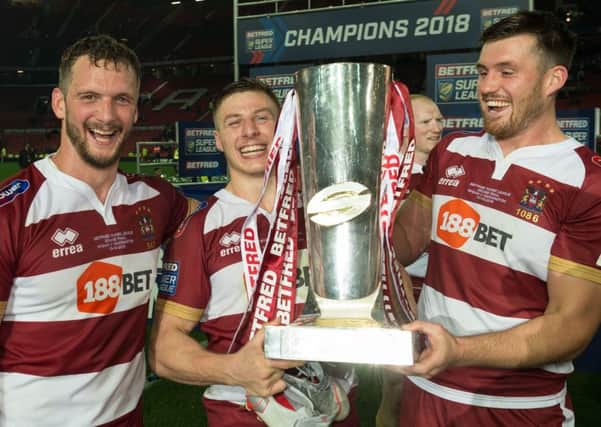 Tom Davies, flanked by Sean O'Loughlin and Joe Greenwood, with the Super League trophy