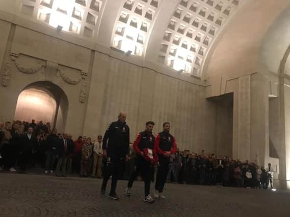 England Head Coach Wayne Bennett and Captain Sean OLoughlin join the youngest member of the squad in laying a wreath at the Menin Gate Memorial to the Missing after the last post