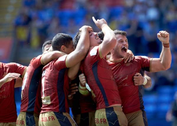 Catalans Dragons players celebrate their Challenge Cup semi-final win over St Helens