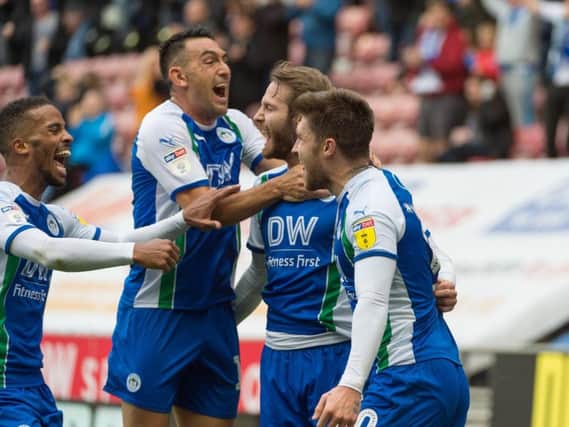 Latics players celebrate their win over West Brom