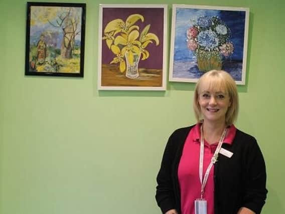 Lucy Atkinson, creative therapies co-ordinator at Wigan and Leigh Hospice, with some of the artwork