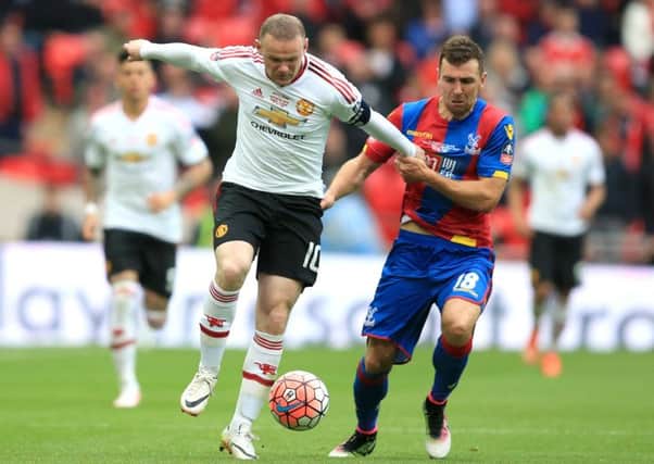 James McArthur competes for the ball with Wayne Rooney