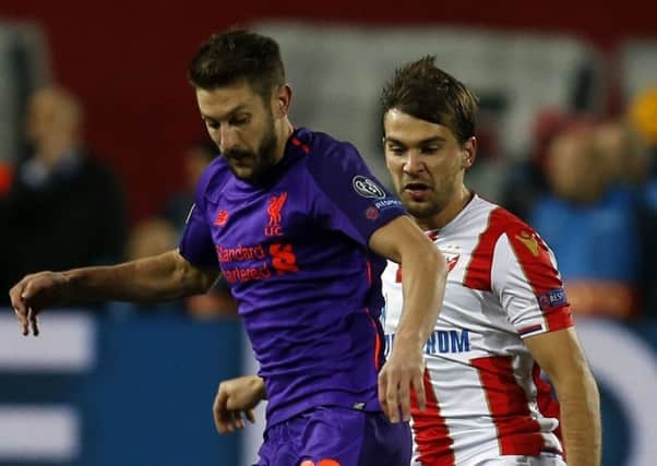 Adam Lallana battles with Red Star's Filip Stojkovic in the Champions League Group C match in Belgrade