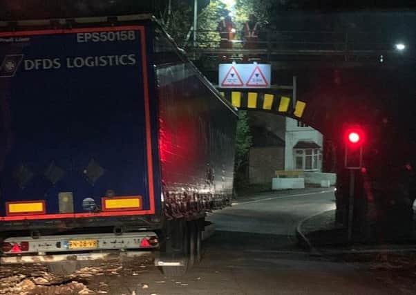 The lorry stuck under Gathurst Road bridge which caused chaos on the roads