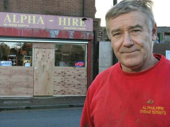 Mark Thompson outside the boarded-up shop