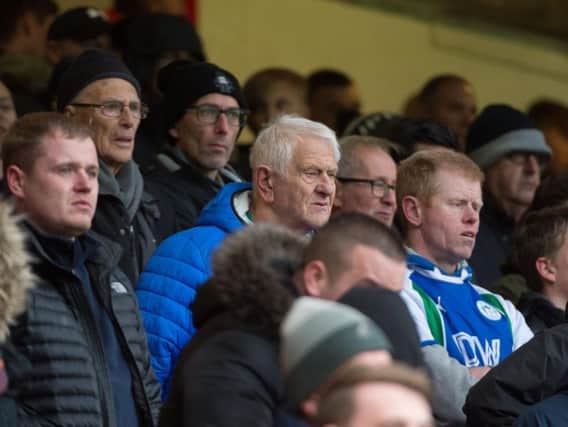 Wigan Athletic fans watching their team in action